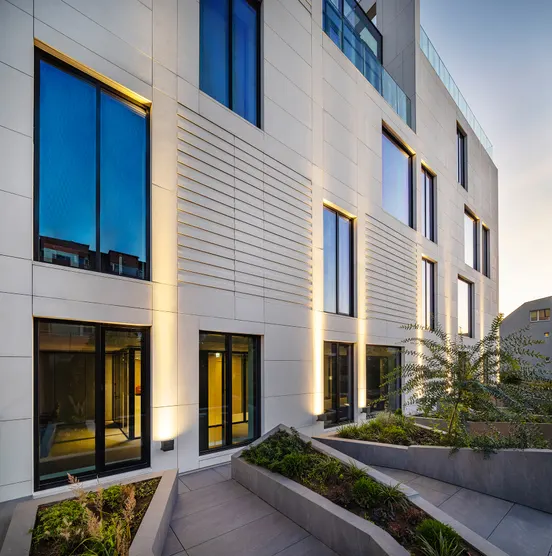Illuminated facade of a completed Vanp Invest development